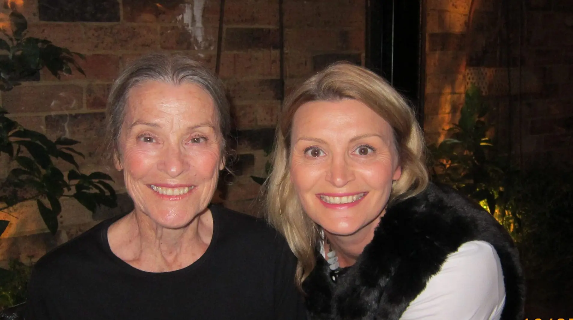 2 women, mother and daughter smiling