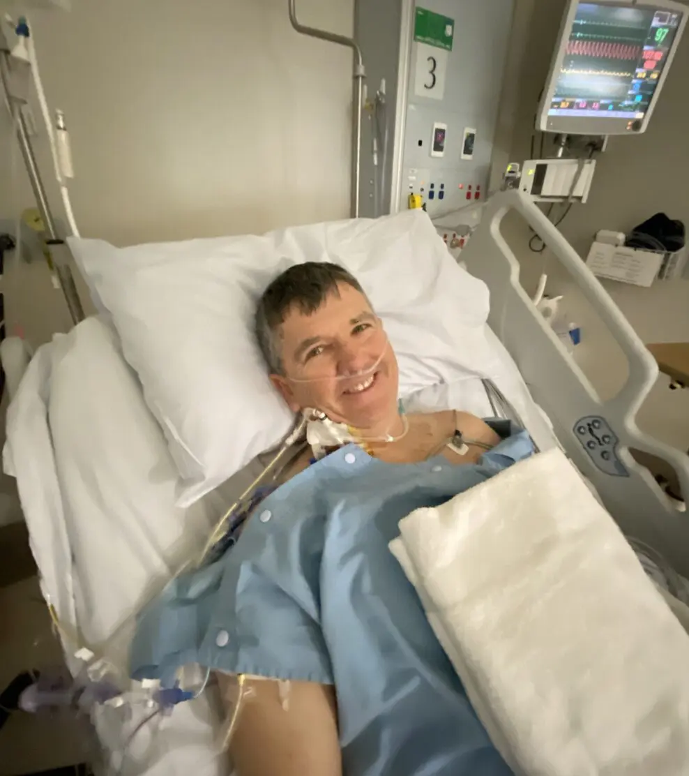 Man lying in a hospital bed after cardiac arrest from heart disease