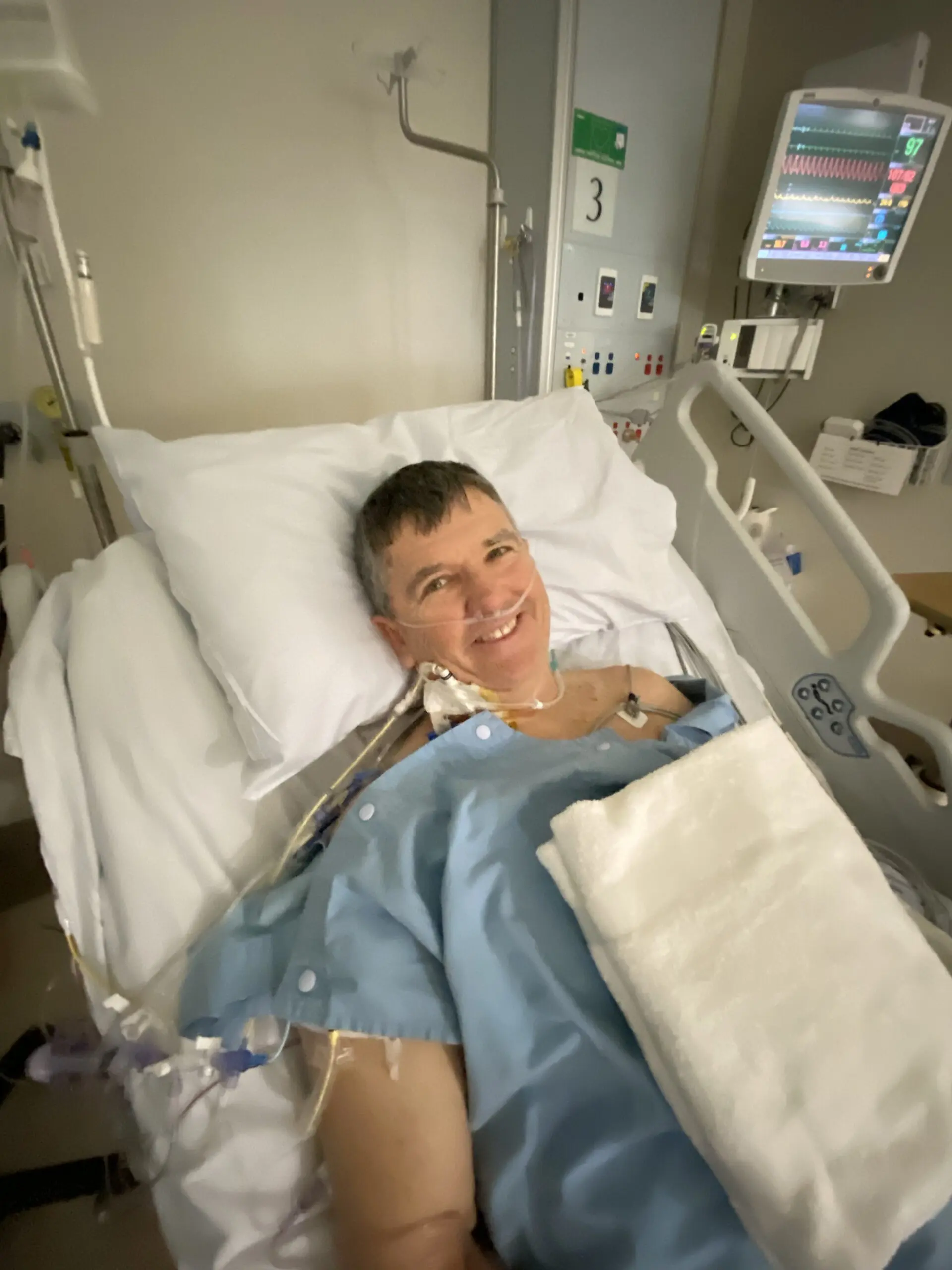 Man lying in a hospital bed after cardiac arrest from heart disease