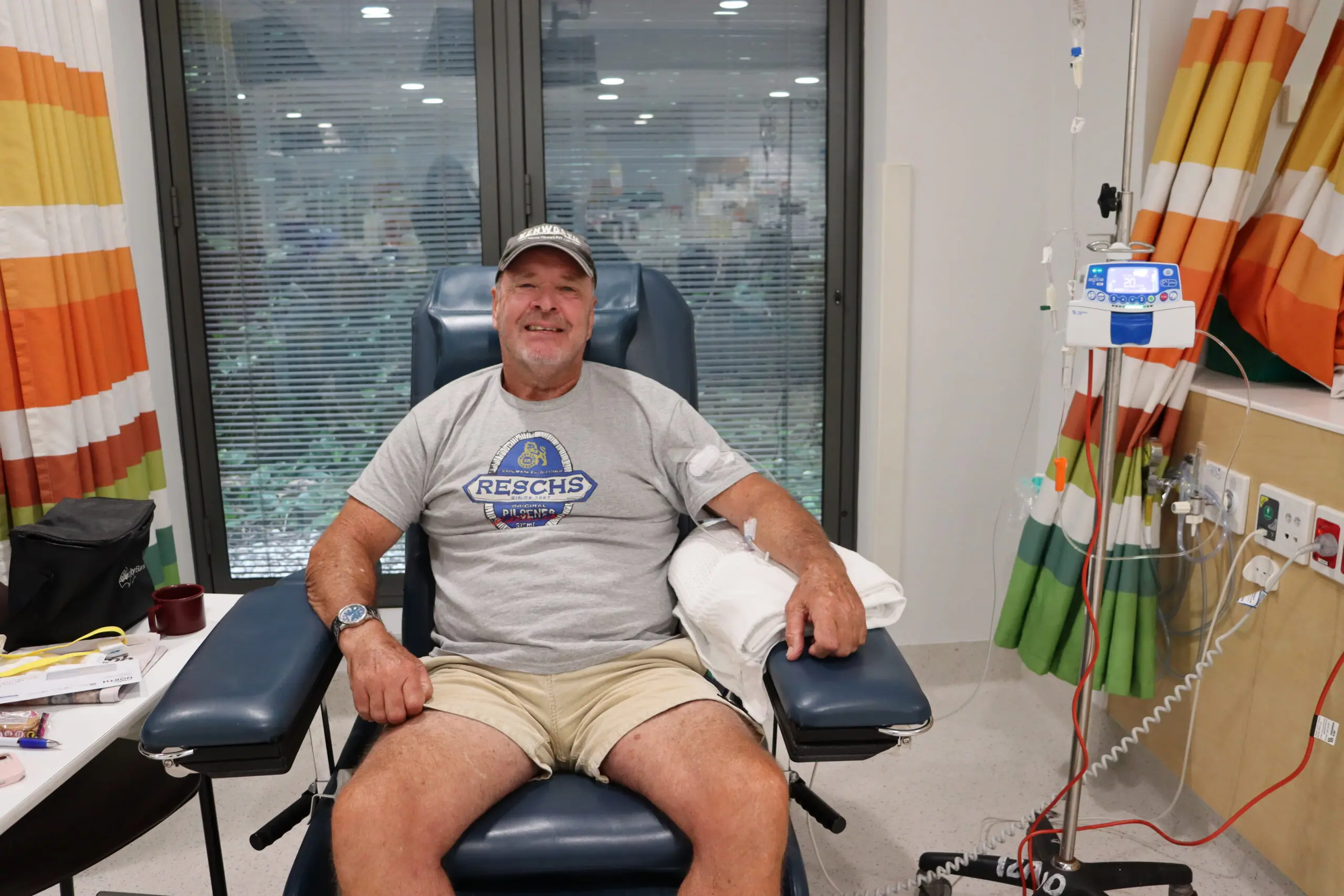 Man in hospital chair smiling