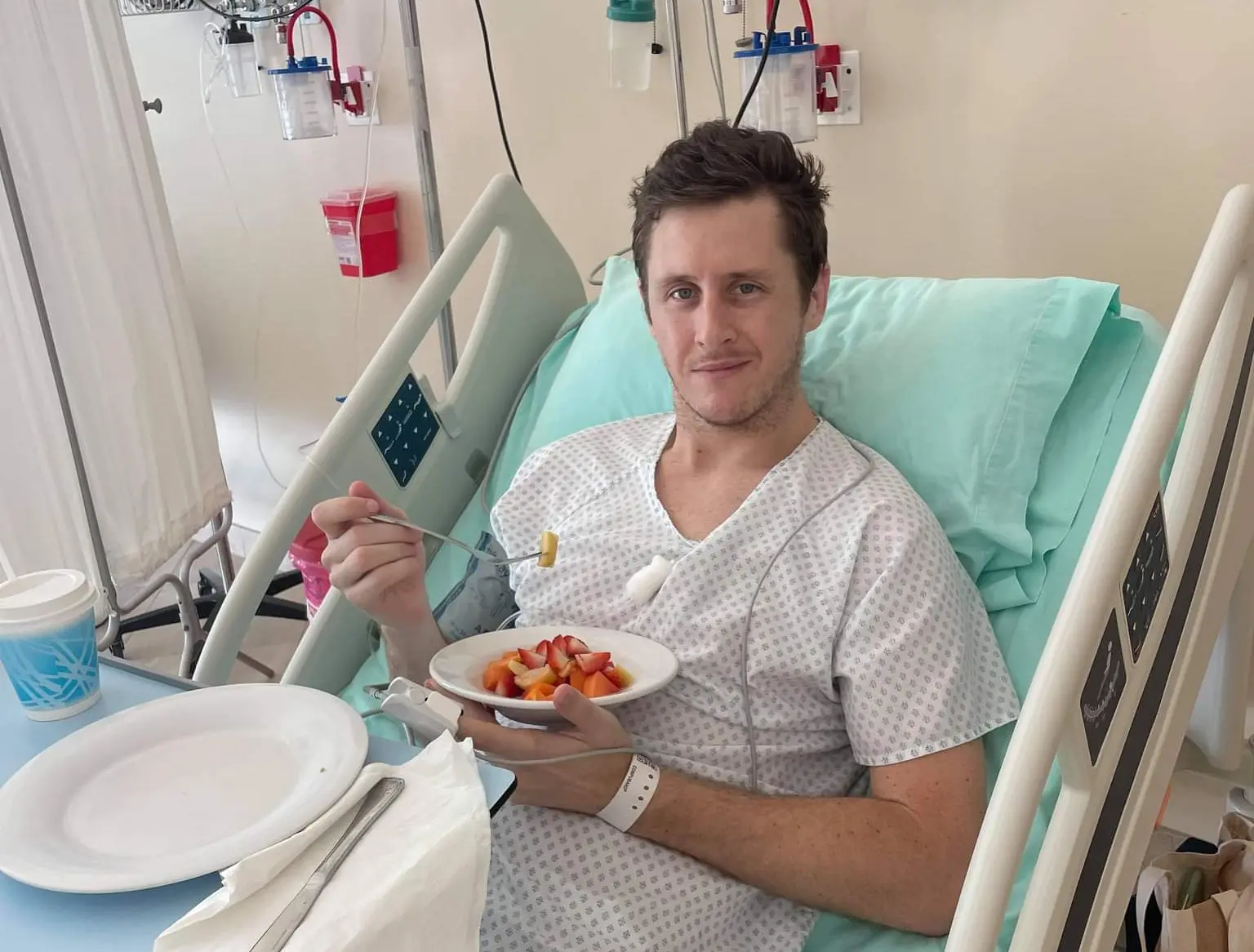 Man in hospital bed eating