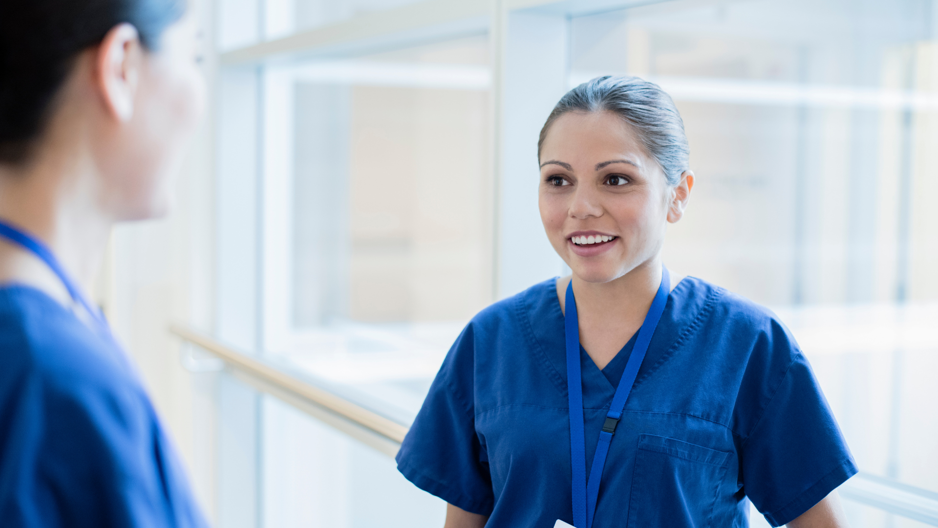 Young Aboriginal Australian doctor talking to colleague