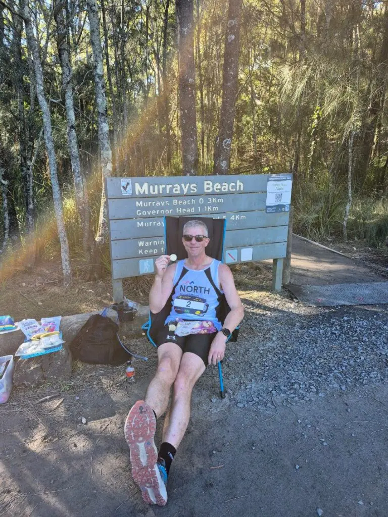 Man refueling and resting on camping chair in the middle on a race for aged care