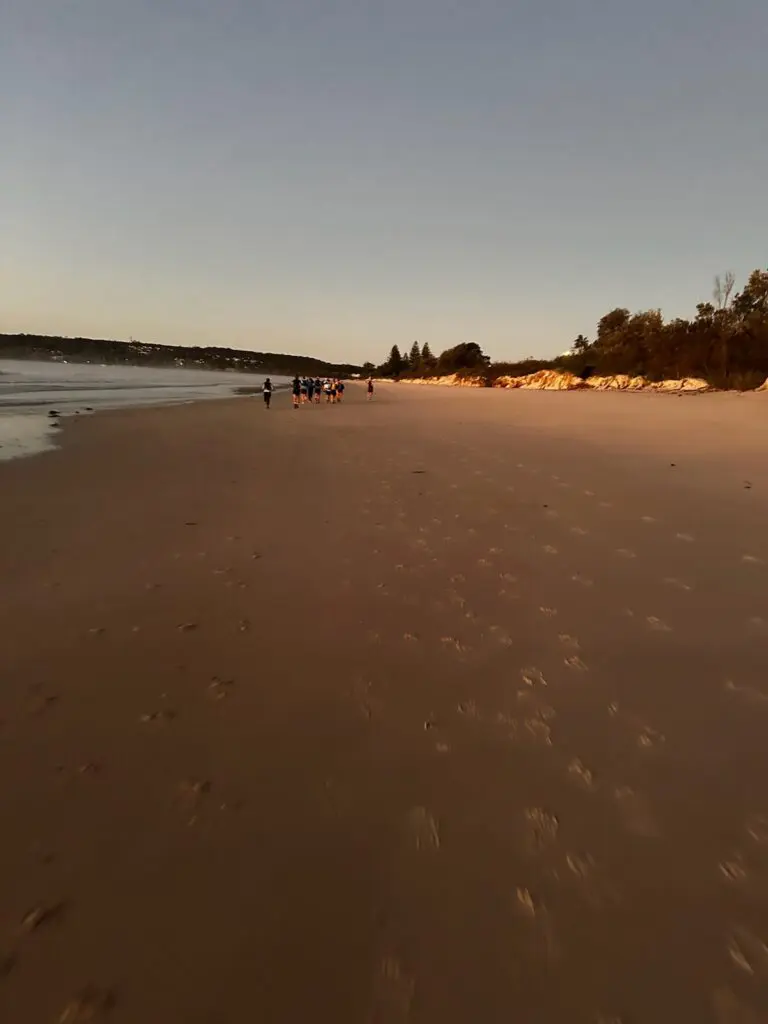 Runners racing on a beach