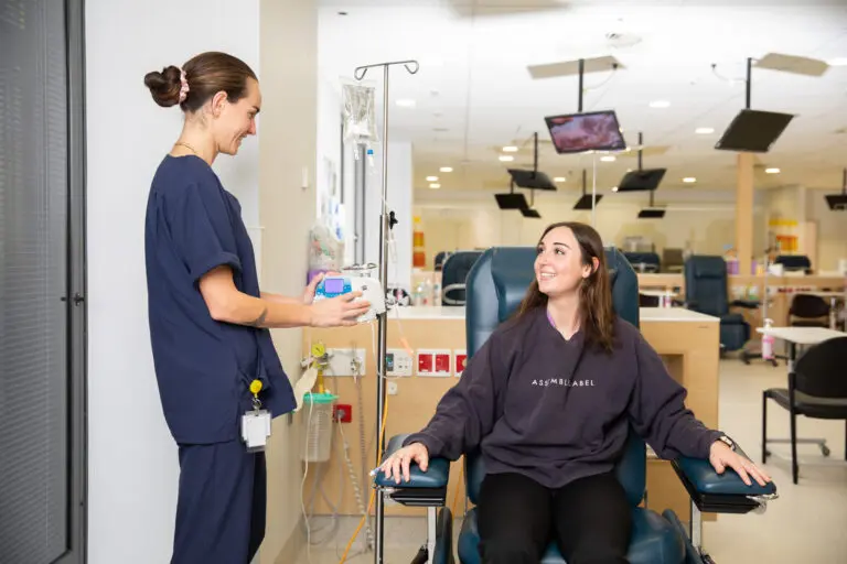 Female nurse with female patient in hospital