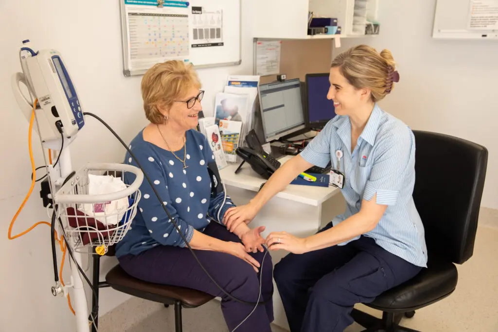 Female nurse with female patient in hospital