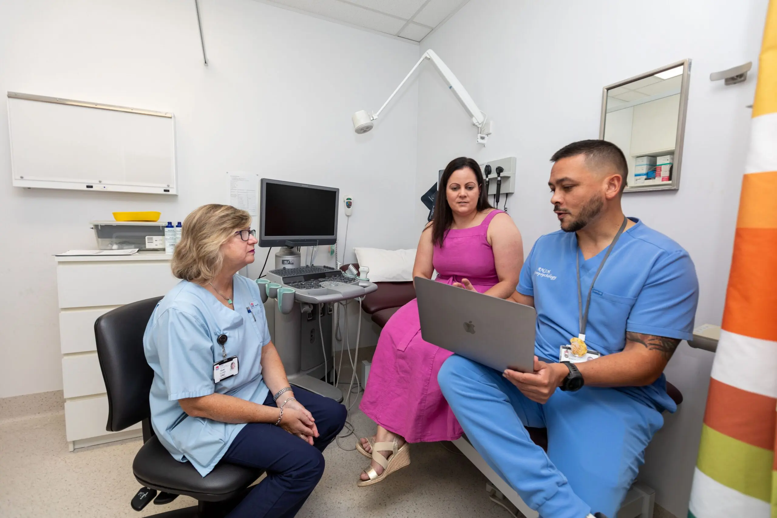 Nurses with patient in hospital explaining concussion test results