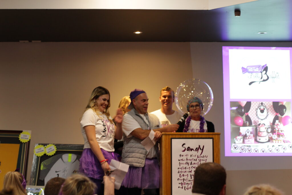 NORTH Foundation, Sandy and family on stage at Trivia Night fundraiser, pancreatic cancer