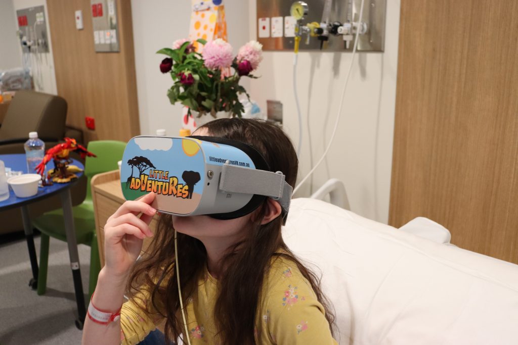 Little girl on hospital bed with virtual reality goggles