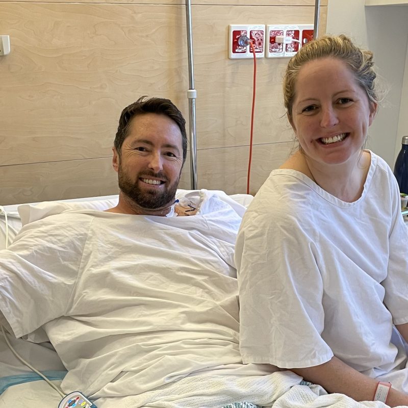 Man and woman on hospital bed smiling