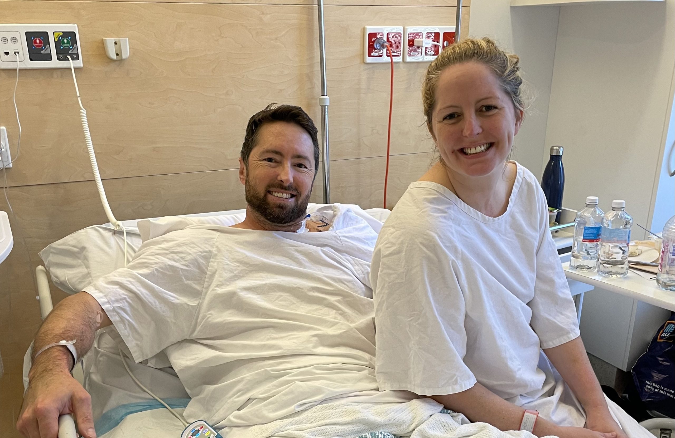 Man and woman on hospital bed smiling