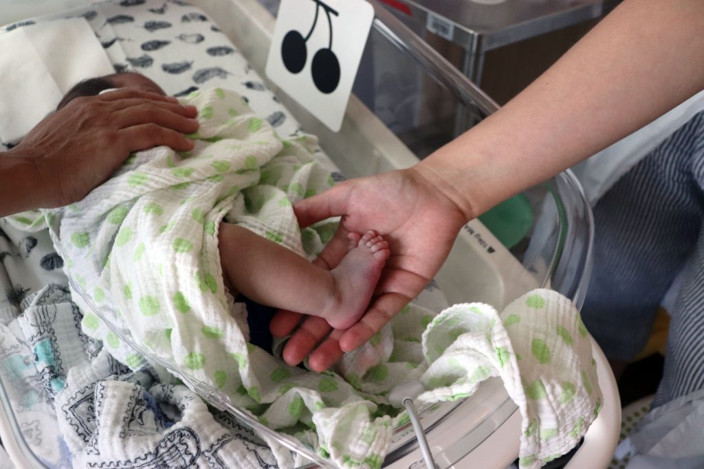 Baby's feet in doctor's hand
