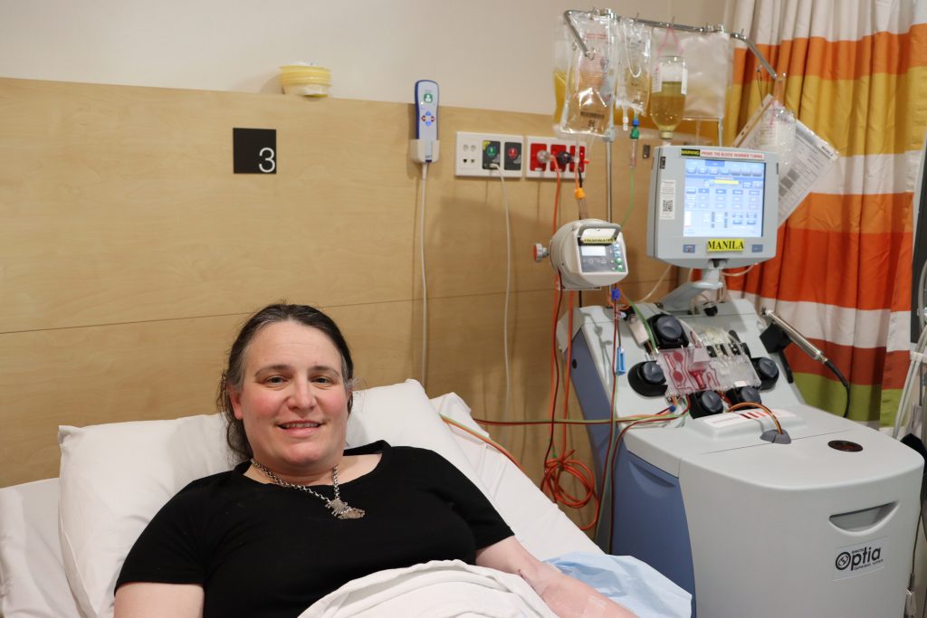 Female in hospital bed smiling