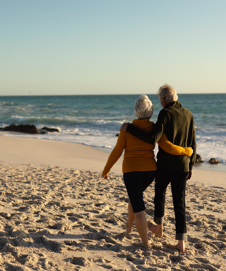 Senior couple walking on the beach