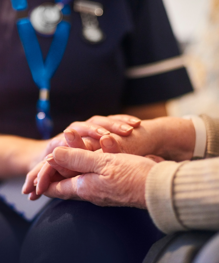 Clinician holding patient's hands