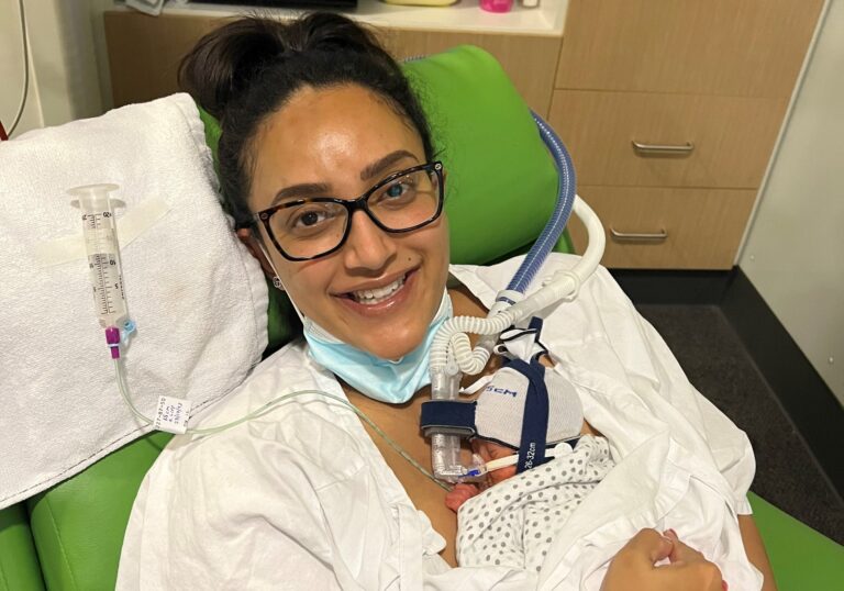 Mother cuddling her baby in hospital