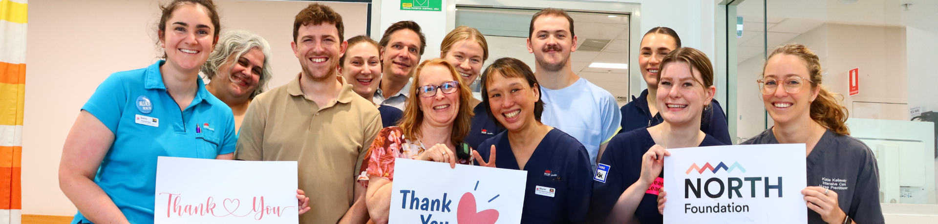 Healthcare staff holding thank you signs for NORTH Foundation Christmas Appeal