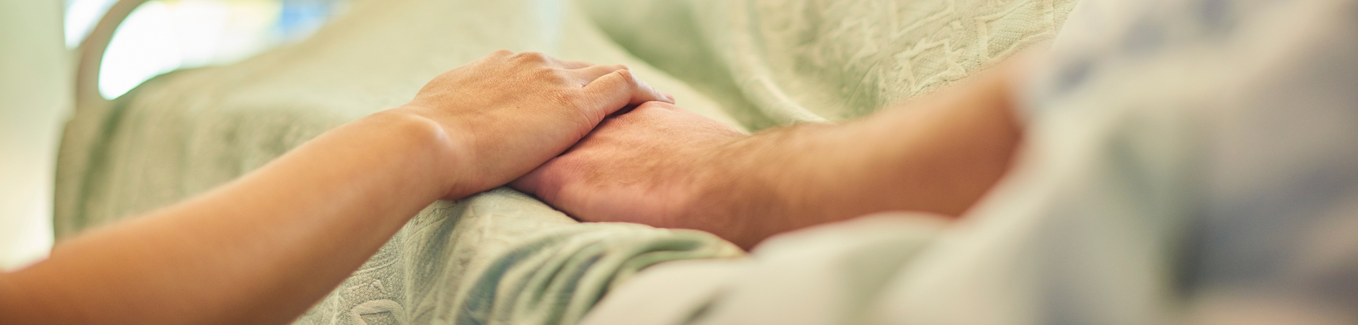 Hand holding in hospital