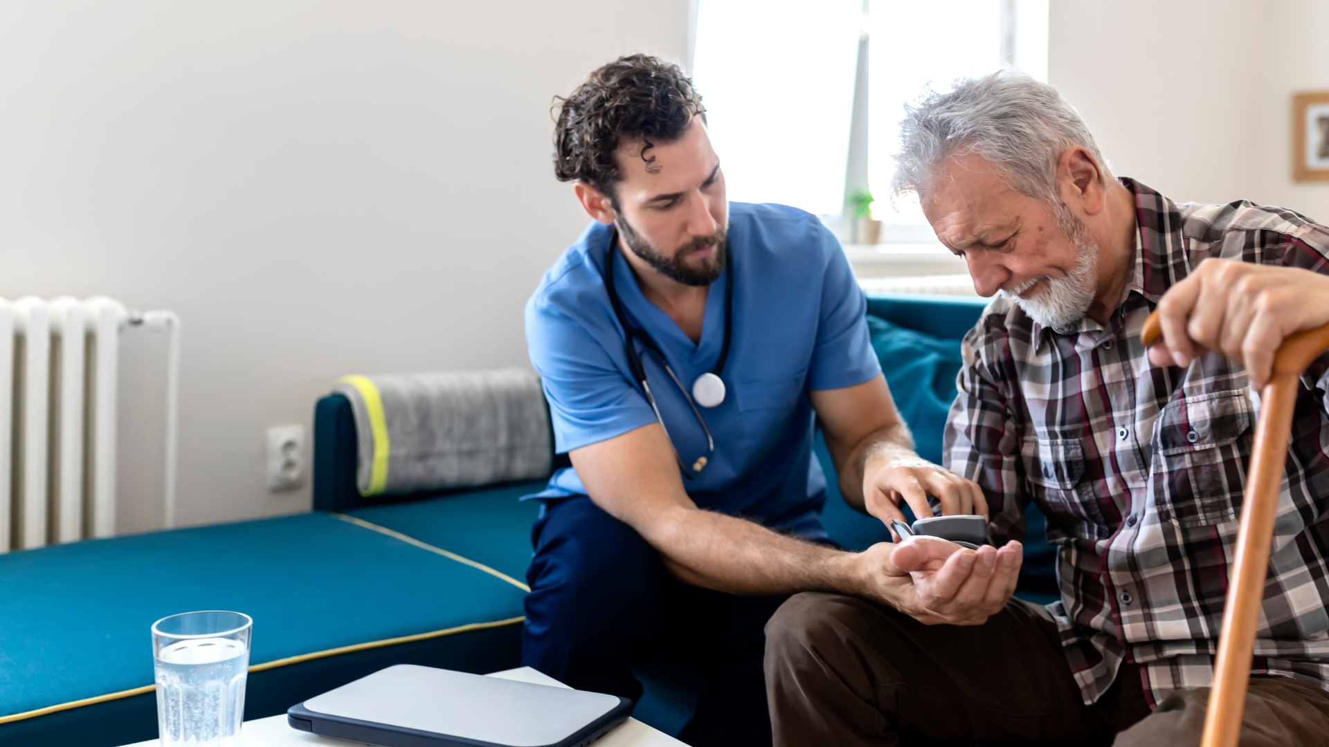 Male nurse providing care to male patient in the comfort of his own home